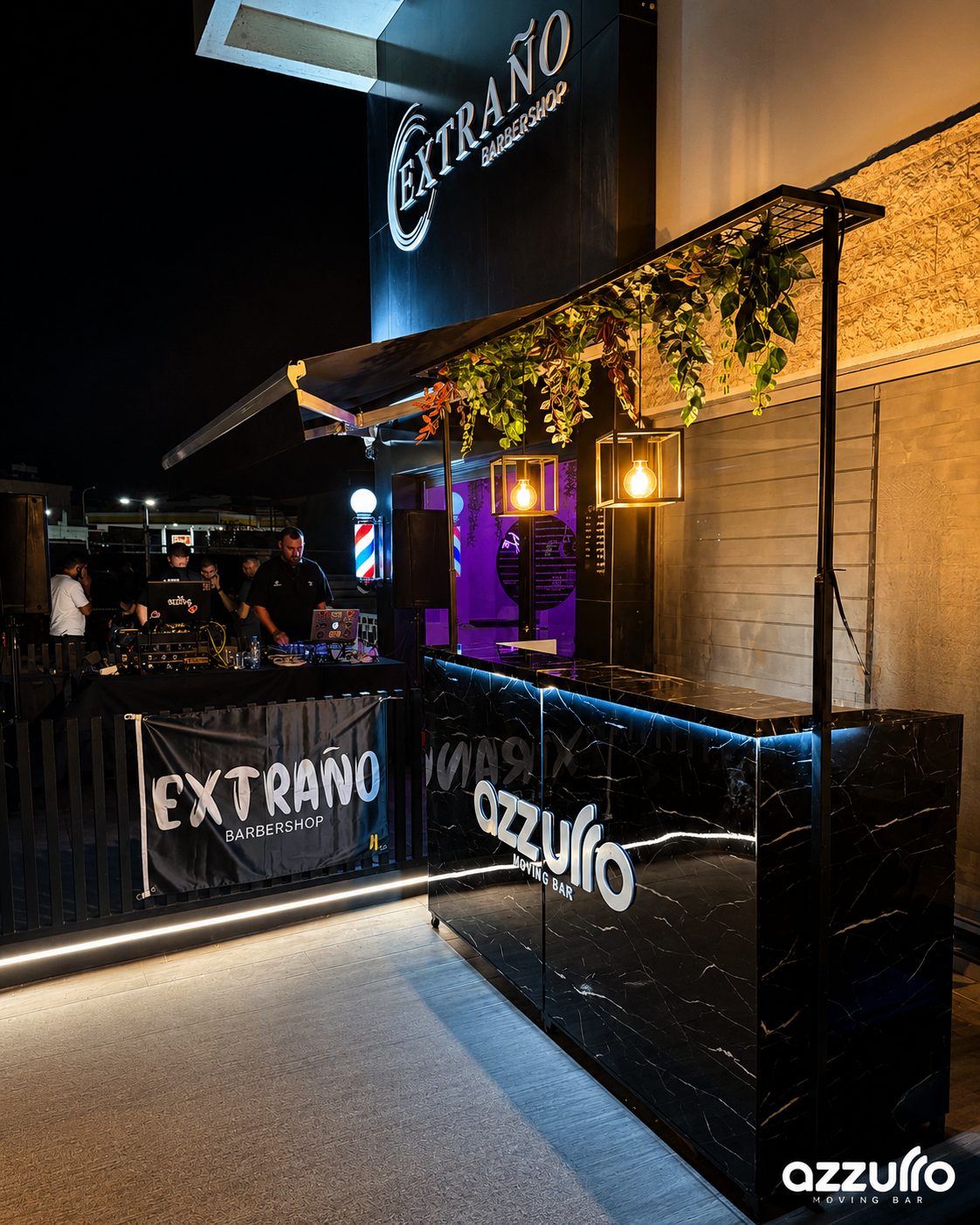 Azzurro Moving Bar collaboration event setup outside a barbershop at night